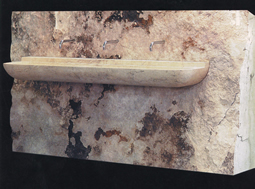 Antique reclaimed stone basin sink salvaged restored and installed in this traditional style Mediterranean home.